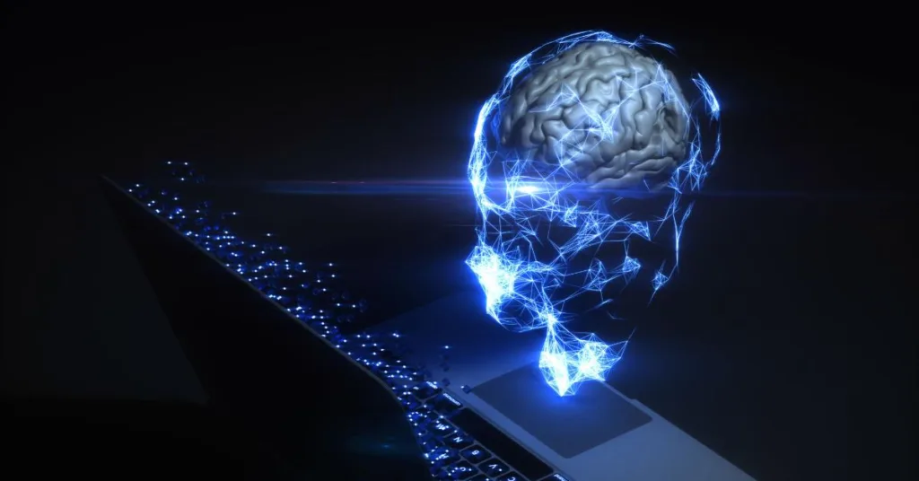 Model mózgu 3d przed laptopem, symbolizujący wysoką skuteczność i wydajność